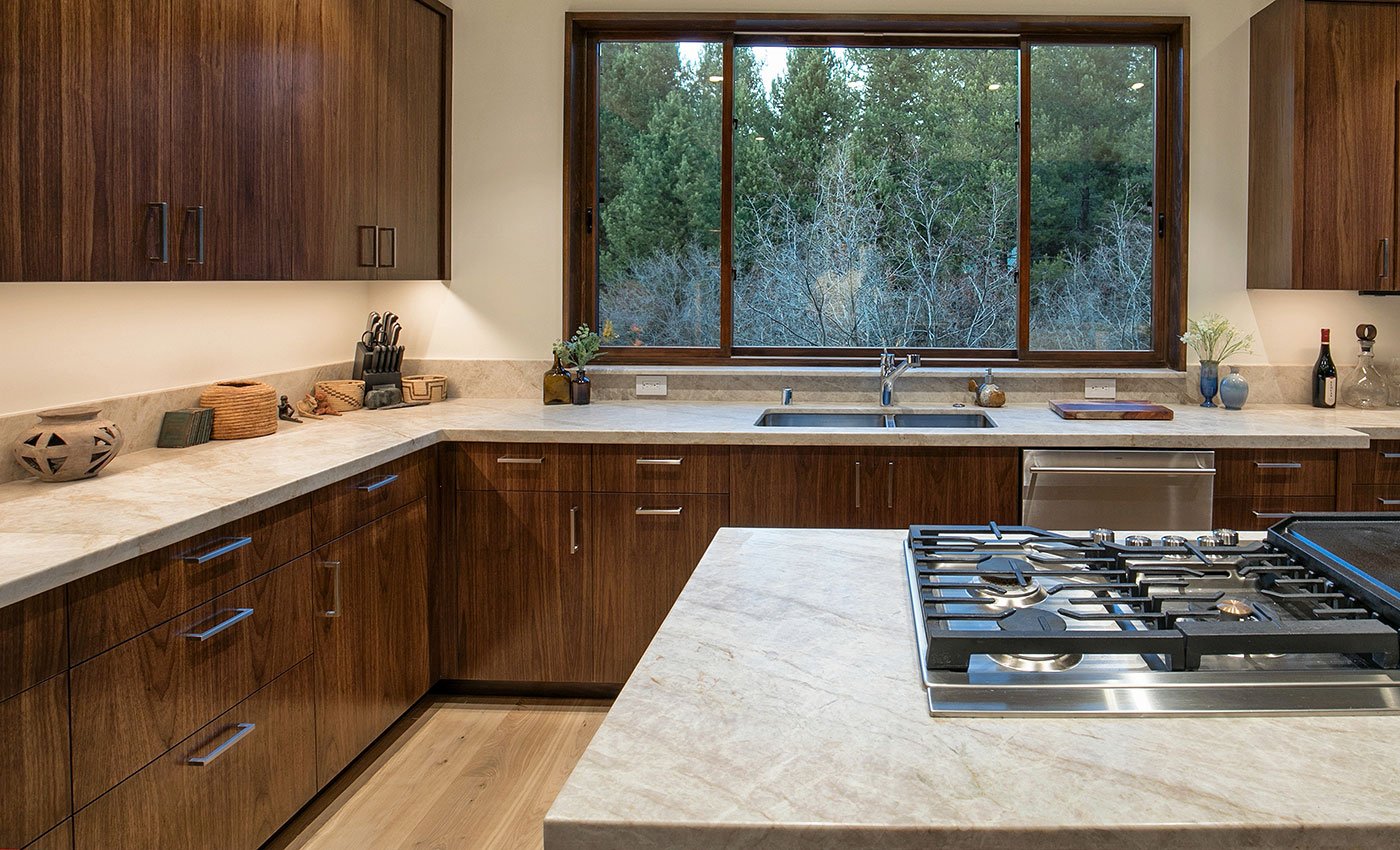 A kitchen with an Andersen® three-sash E-Series Gliding Window above the sink.