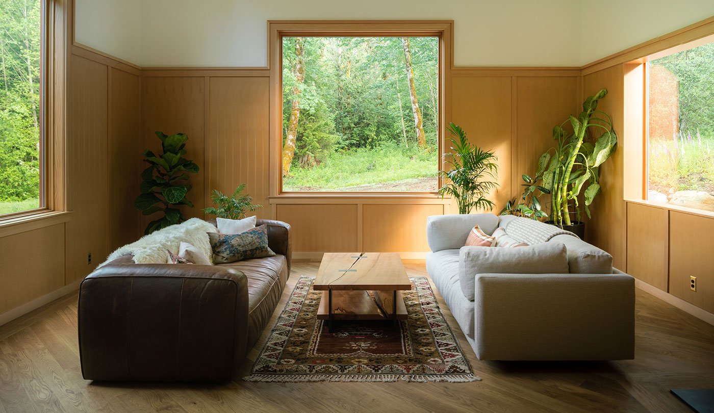 A living room is bathed in natural light from three different directions.