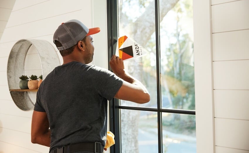 Andersen Certified Contractor removing performance sticker from newly installed window