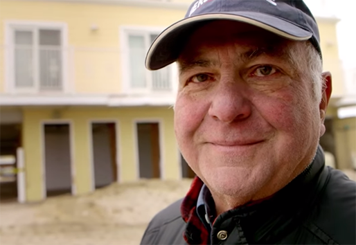 portrait of man in front of home
